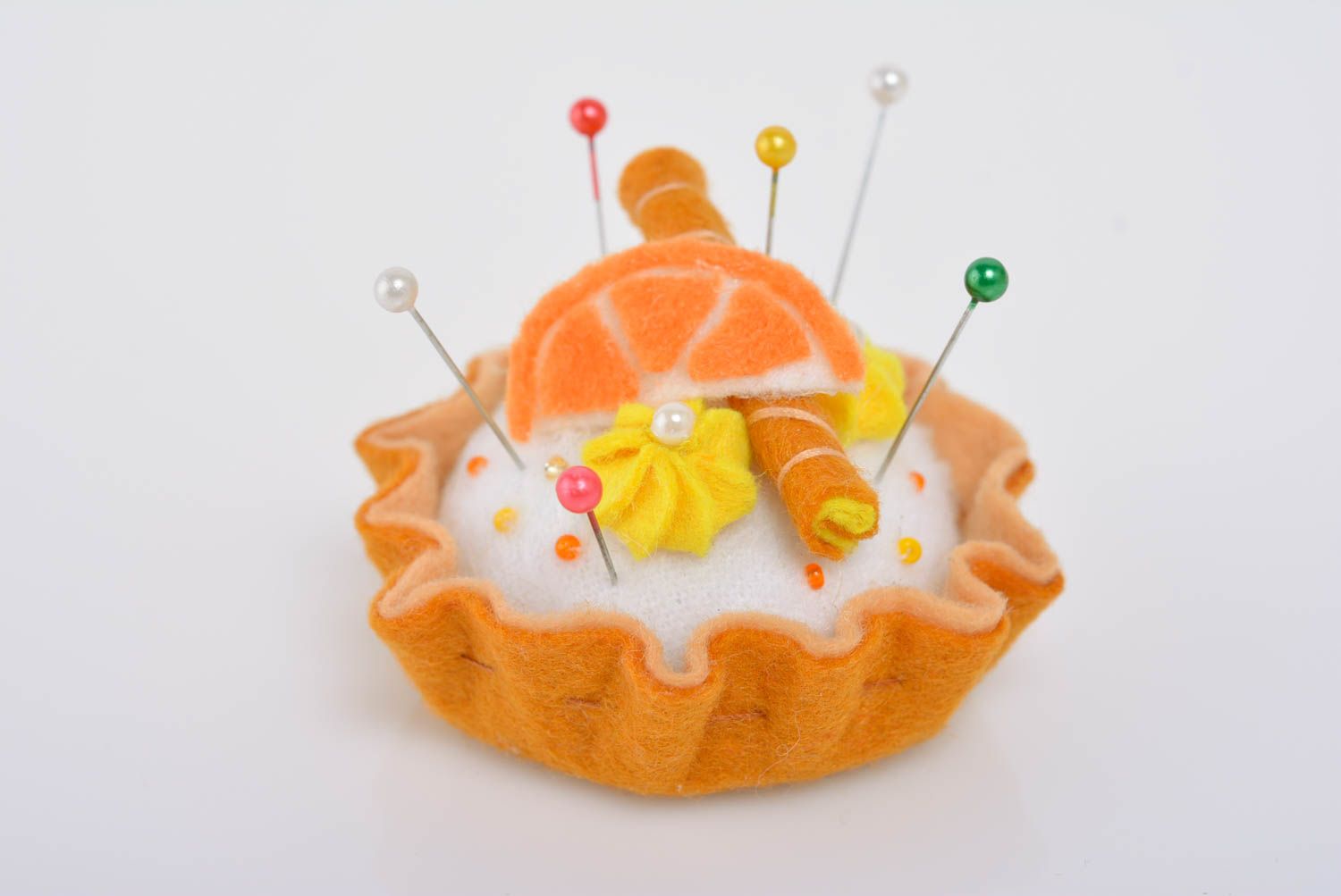 Handmade designer decorative soft pincushion sewn of felt bright orange cake photo 1