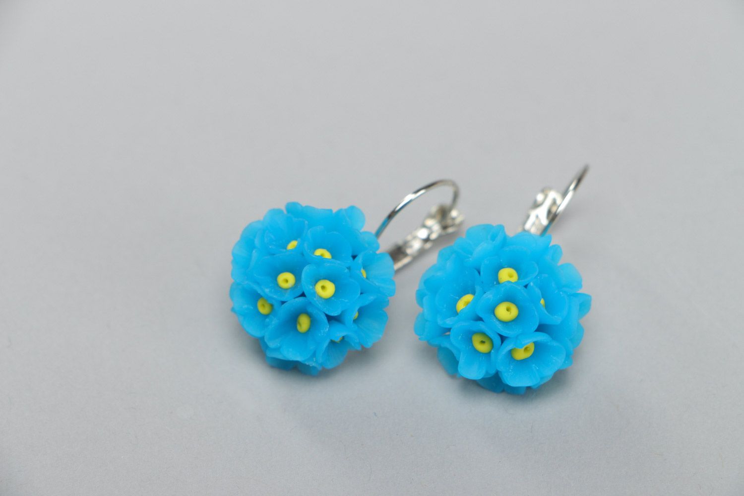 Small handmade polymer clay dangling earrings in the shape of blue flowers photo 2