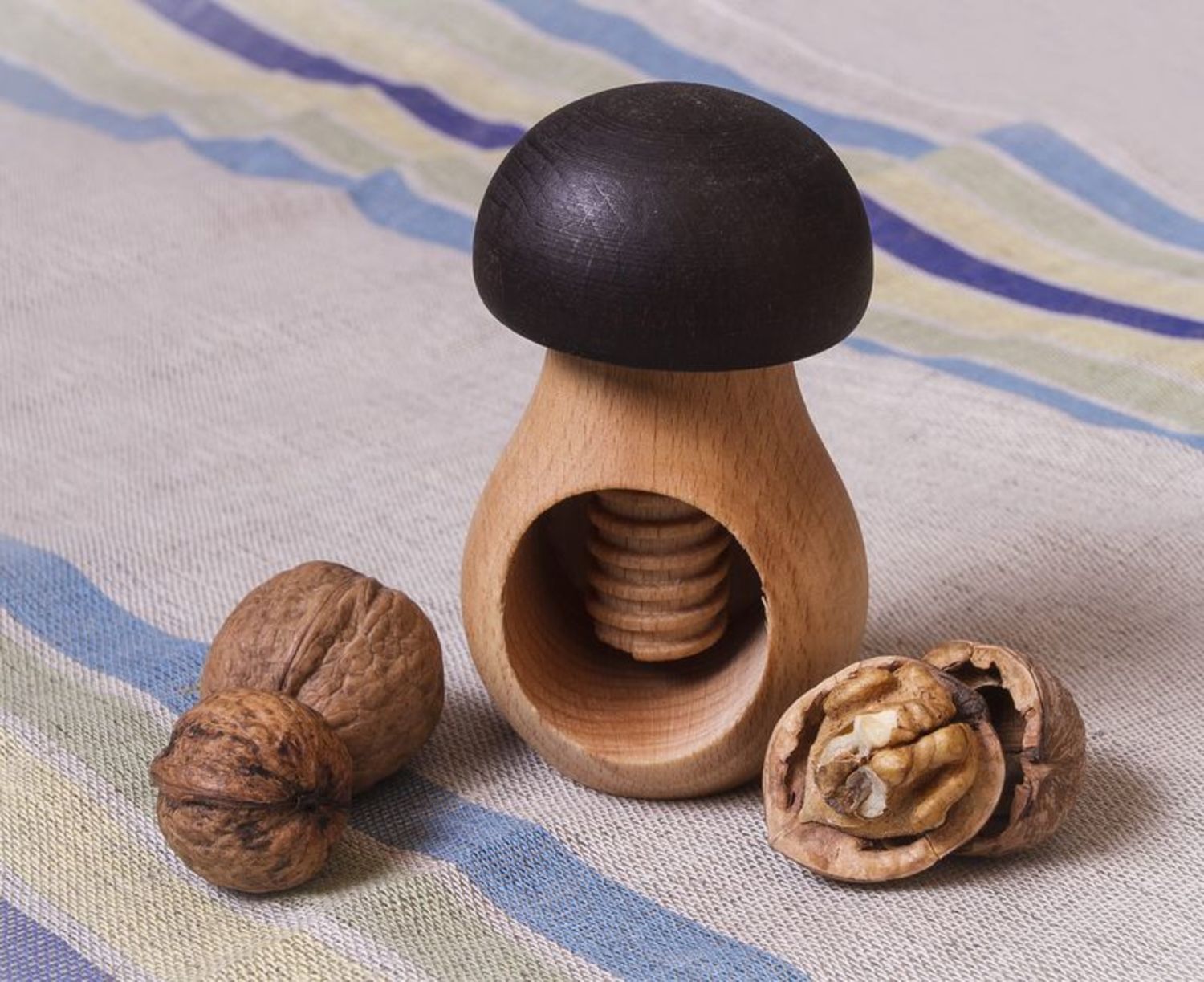 Wooden nutcracker in the shape of a mushroom photo 1