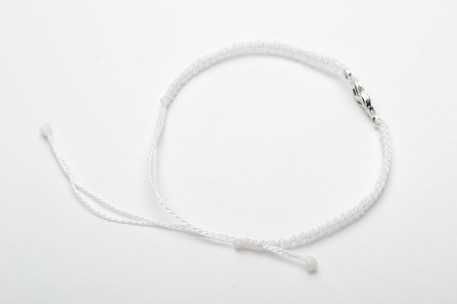 This handmade white friendship wrist bracelet woven using macrame technique photo 4