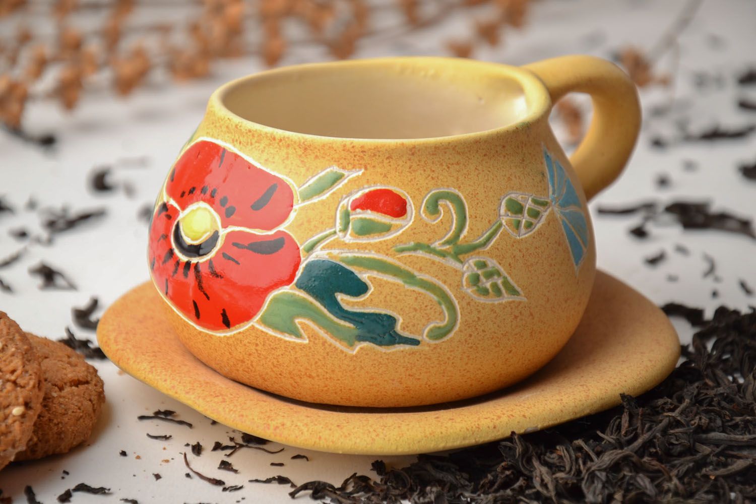 Yellow clay art teacup with handle and saucer and red floral pattern photo 1
