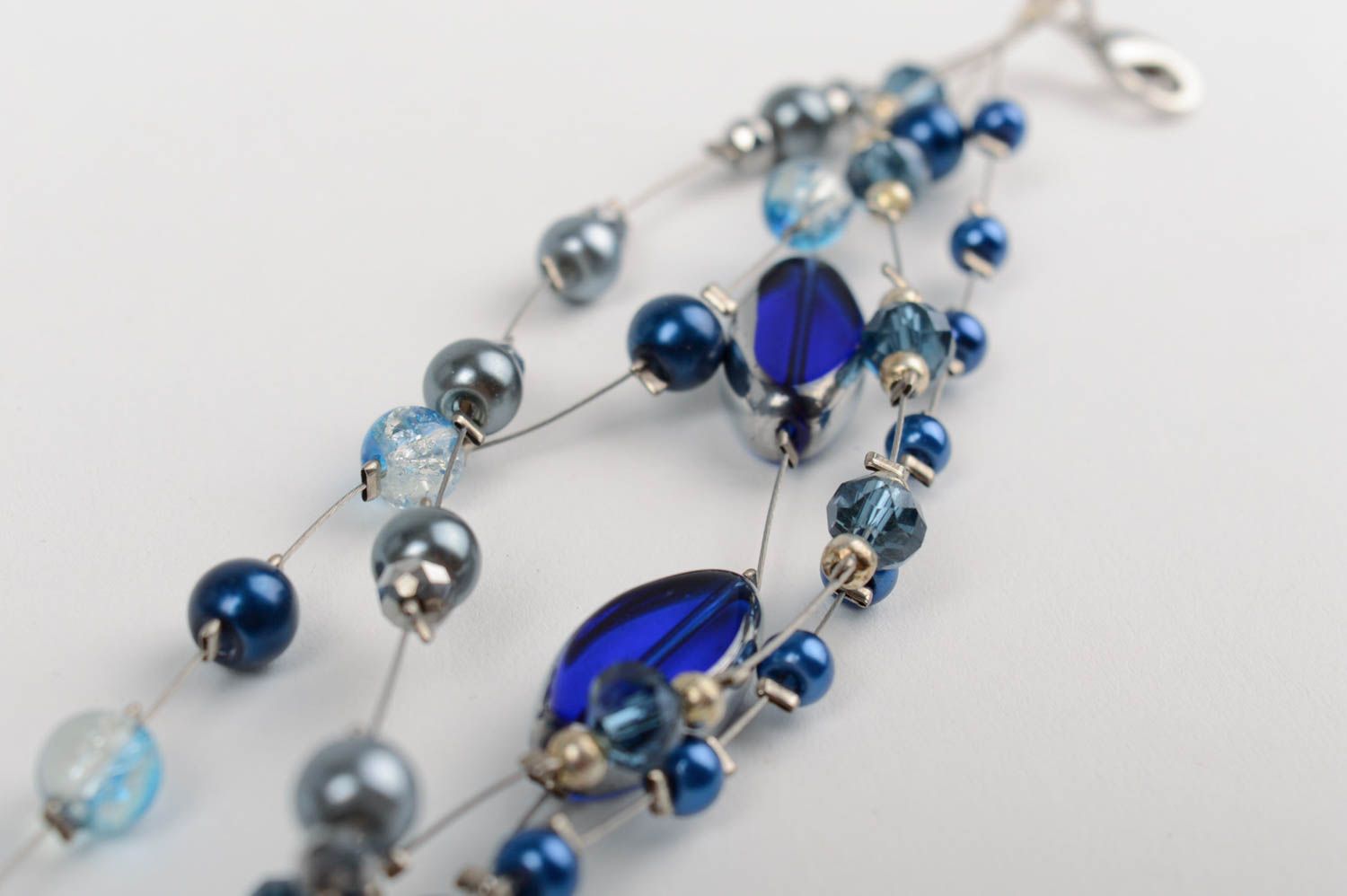 Handmade designer wrist bracelet with dark blue ceramic pearls and crystal beads photo 4