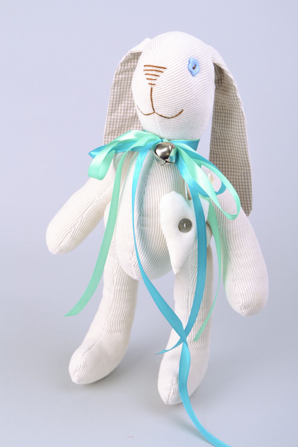 Handmade designer soft toy rabbit sewn of fabric of white color with blue bow photo 3