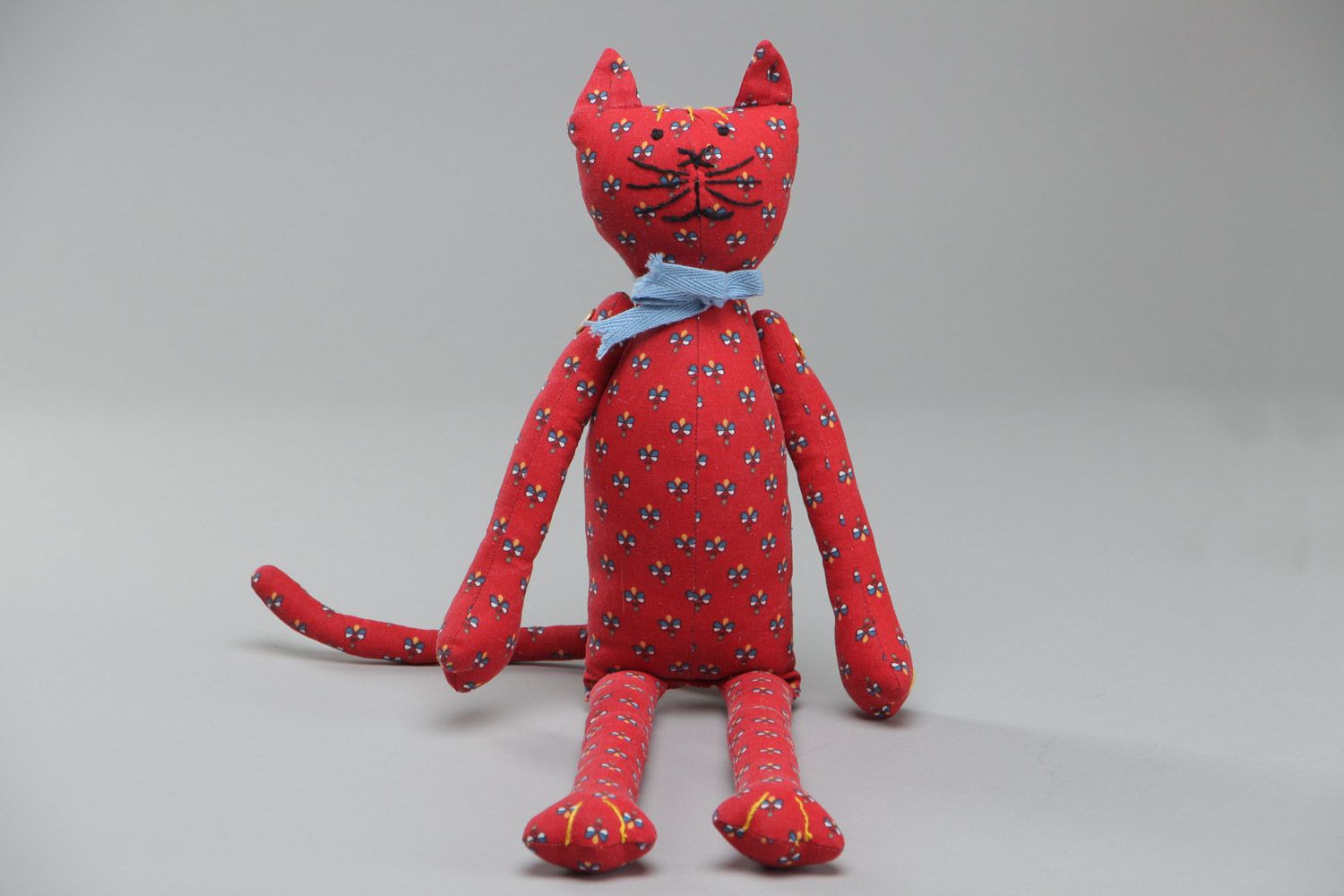 Beautiful homemade soft toy sewn of red fabric with floral pattern Cat with bow photo 2