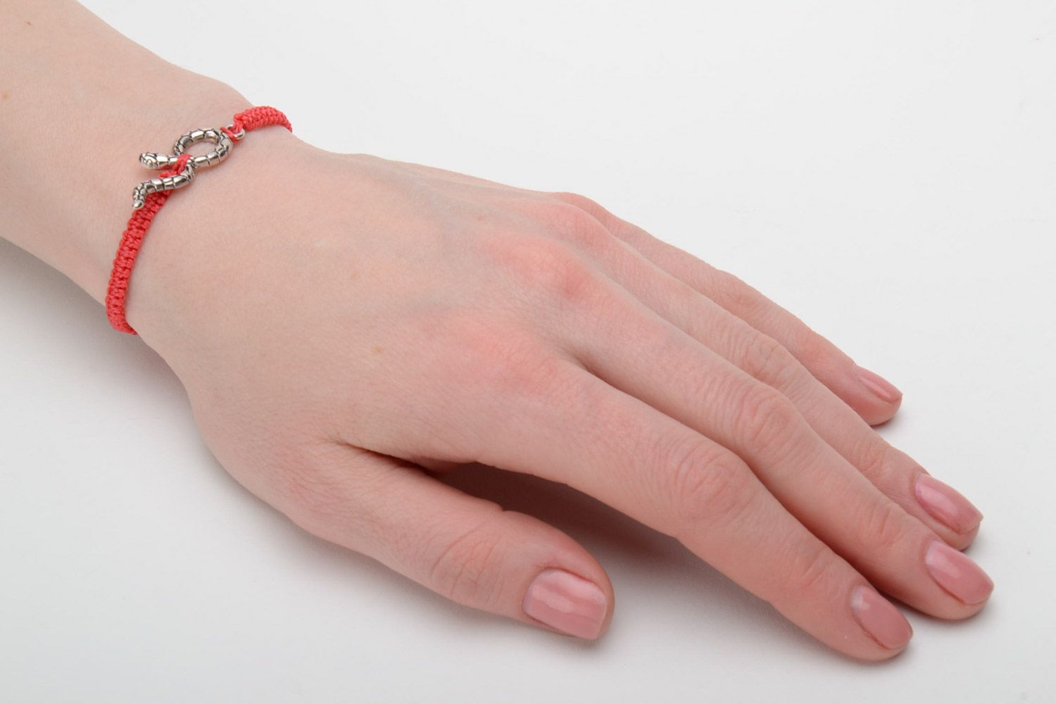 Handmade designer women's macrame bracelet of red color with metal snake charm photo 2