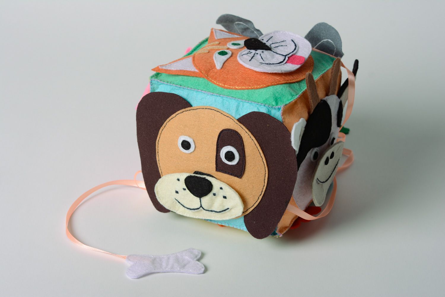 Colorful handmade educational cube sewn of felt with ribbons and charms for kids photo 2