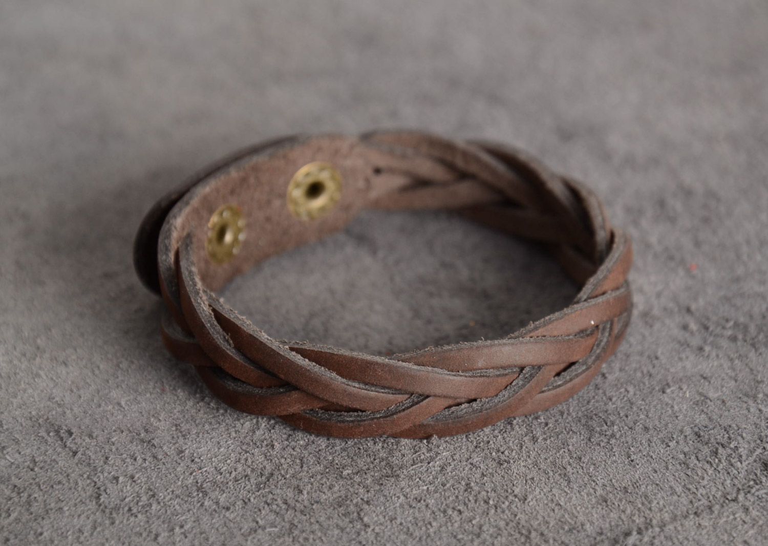 Handmade wrist bracelet woven of brown genuine leather with metal studs photo 1