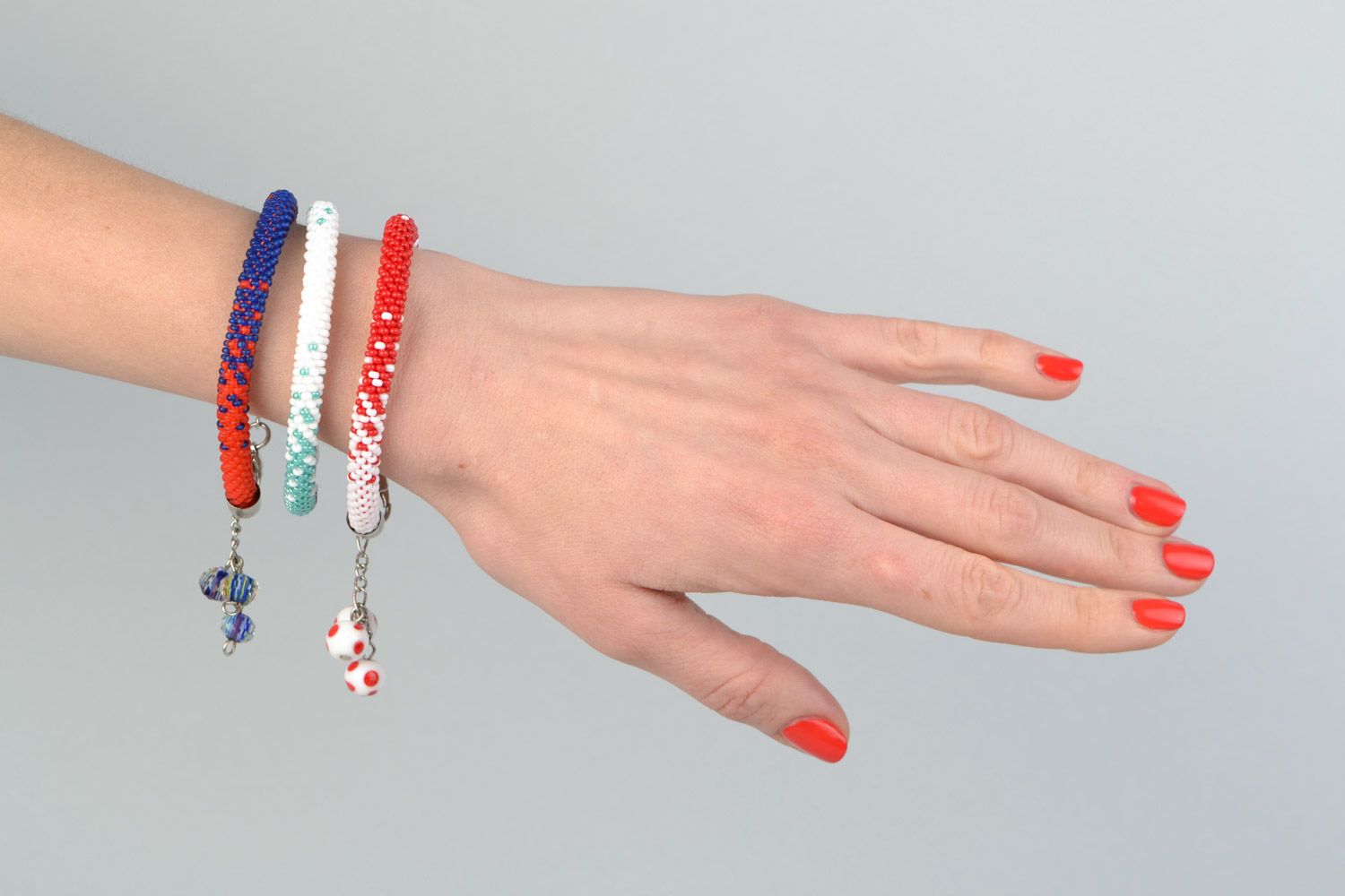 Set of 3 handmade beaded cord bracelets in combinations of white red and blue photo 1