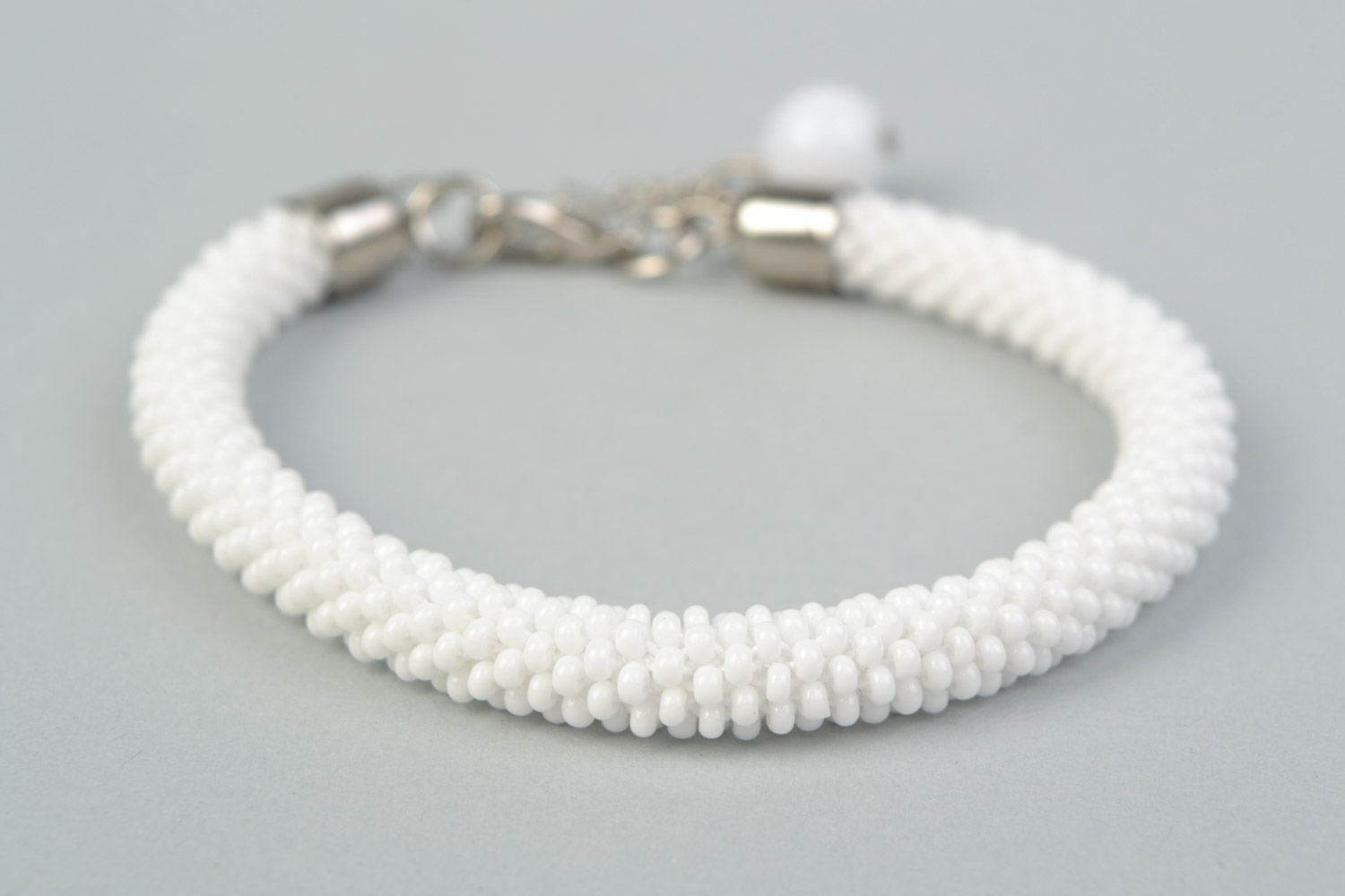Handmade festive wrist cord bracelet crocheted of Czech beads in white color photo 3