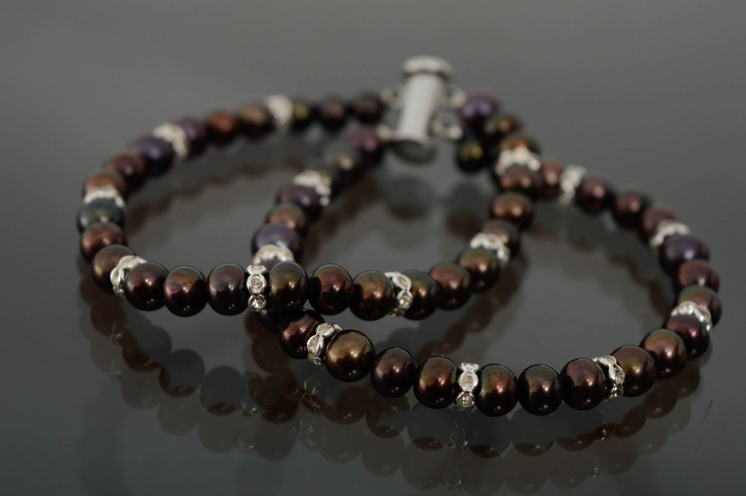 Designer bracelet with dark pearls photo 1