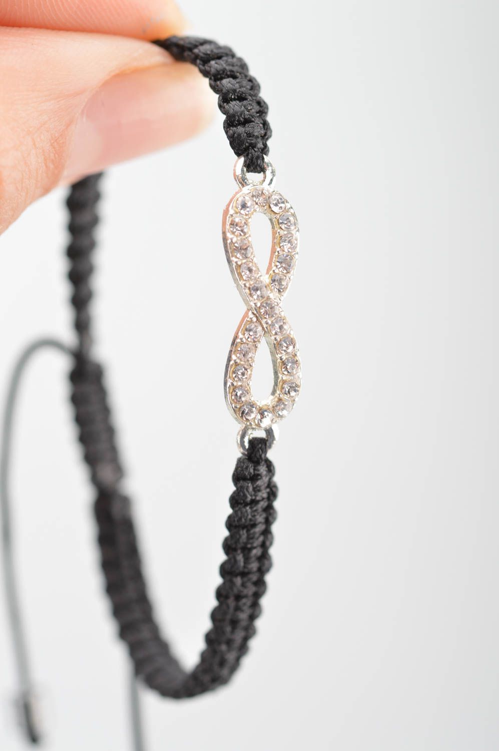 Handmade cute thin black woven wrist bracelet made of silk with insert photo 3