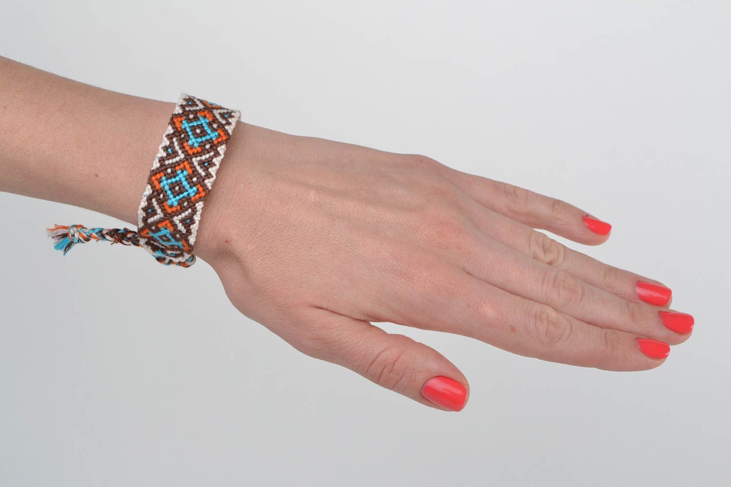 Handmade designer friendship wrist bracelet with ethnic ornament brown and blue photo 2