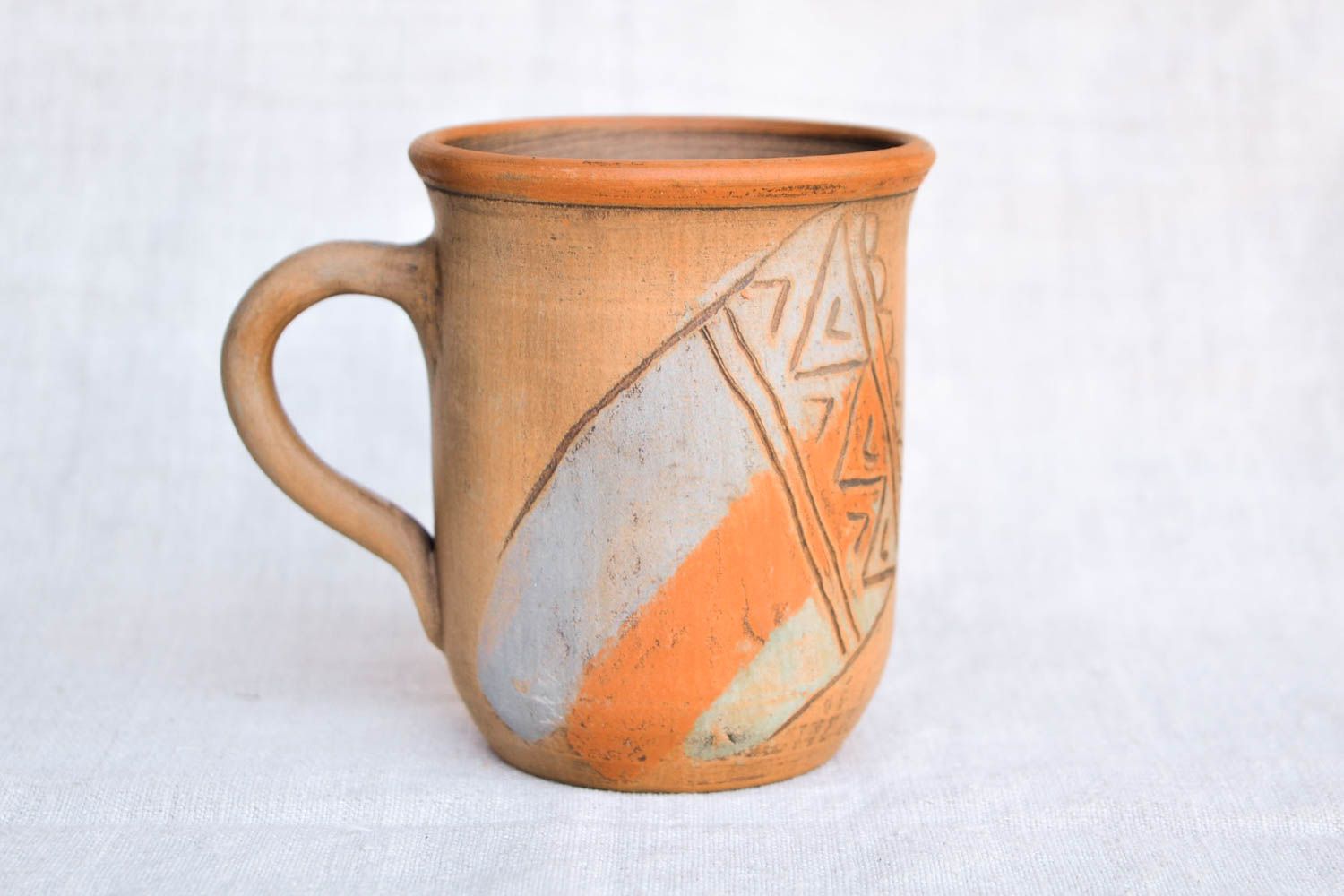 Tall drinking mug in brown, orange, and olive colors photo 1