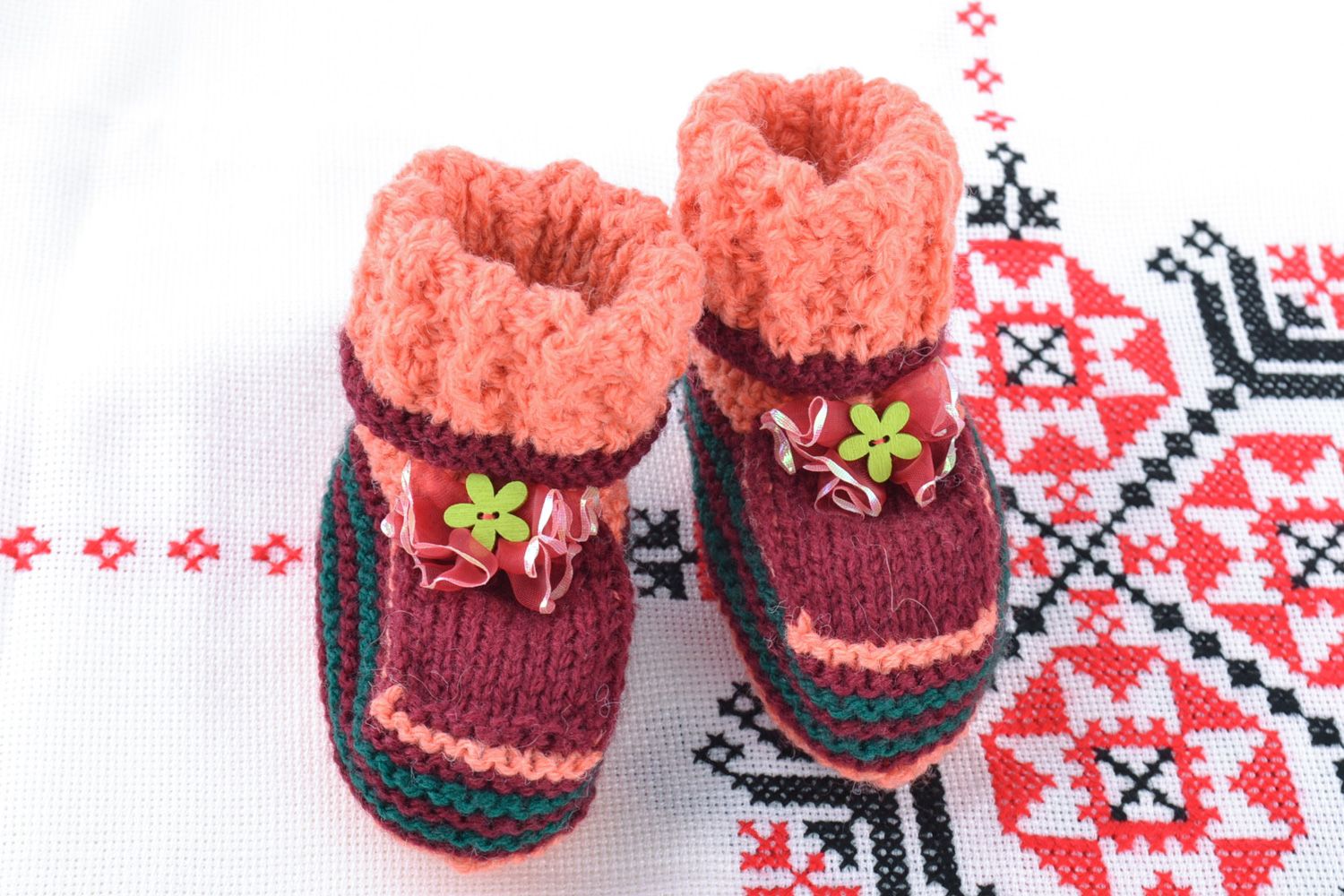 Small soft handmade baby booties knitted of natural wool in pink color palette photo 1