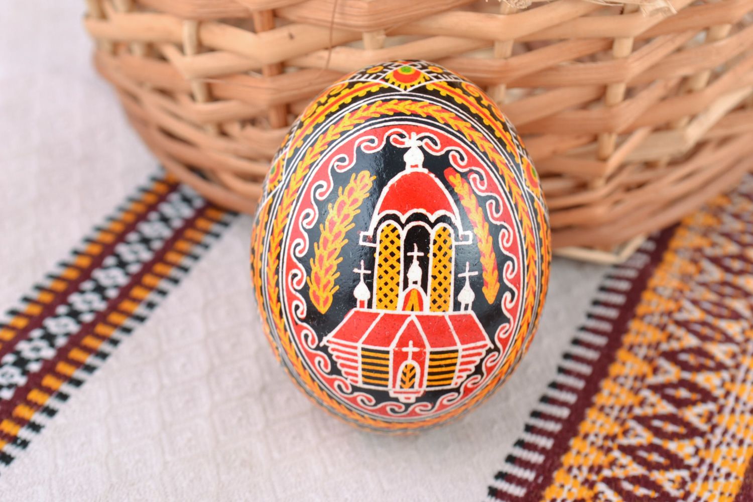 Bright multi-colored handmade painted chicken egg with church image for Easter photo 1