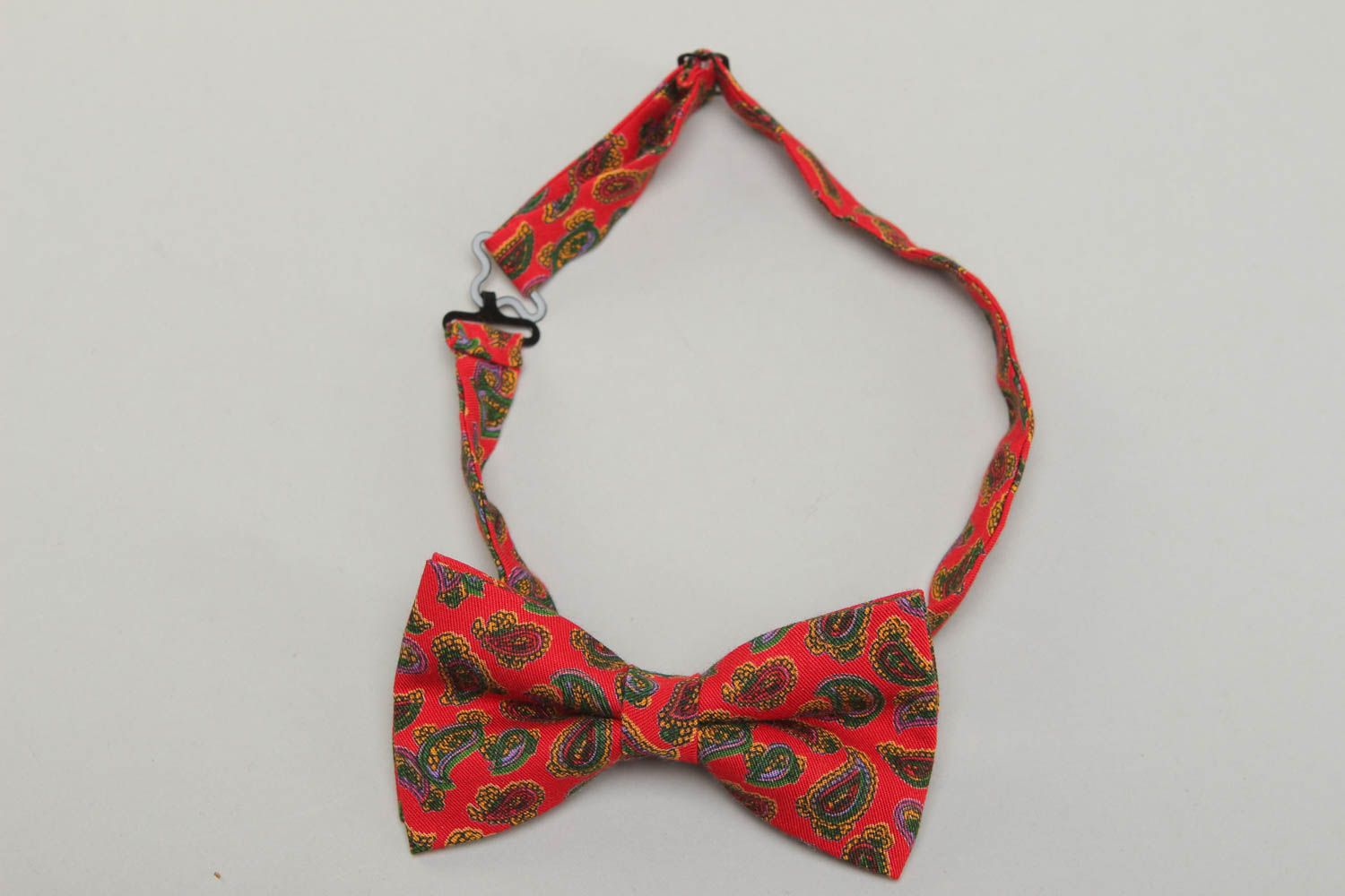 Red fabric bow tie with ornament photo 1