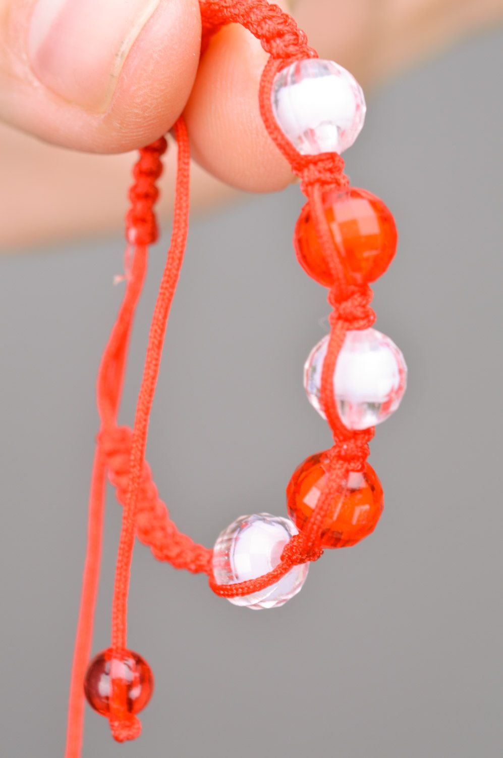 Beautiful bright handmade children's bracelet woven of threads and beads photo 3