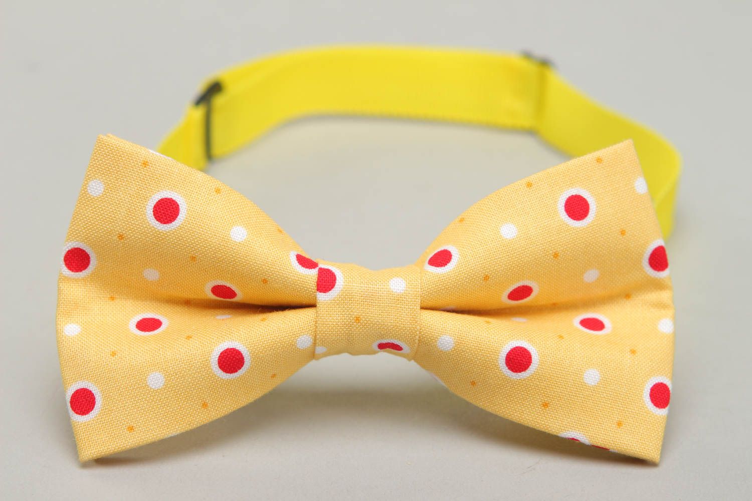 Bow tie made of yellow polka dot fabric photo 2