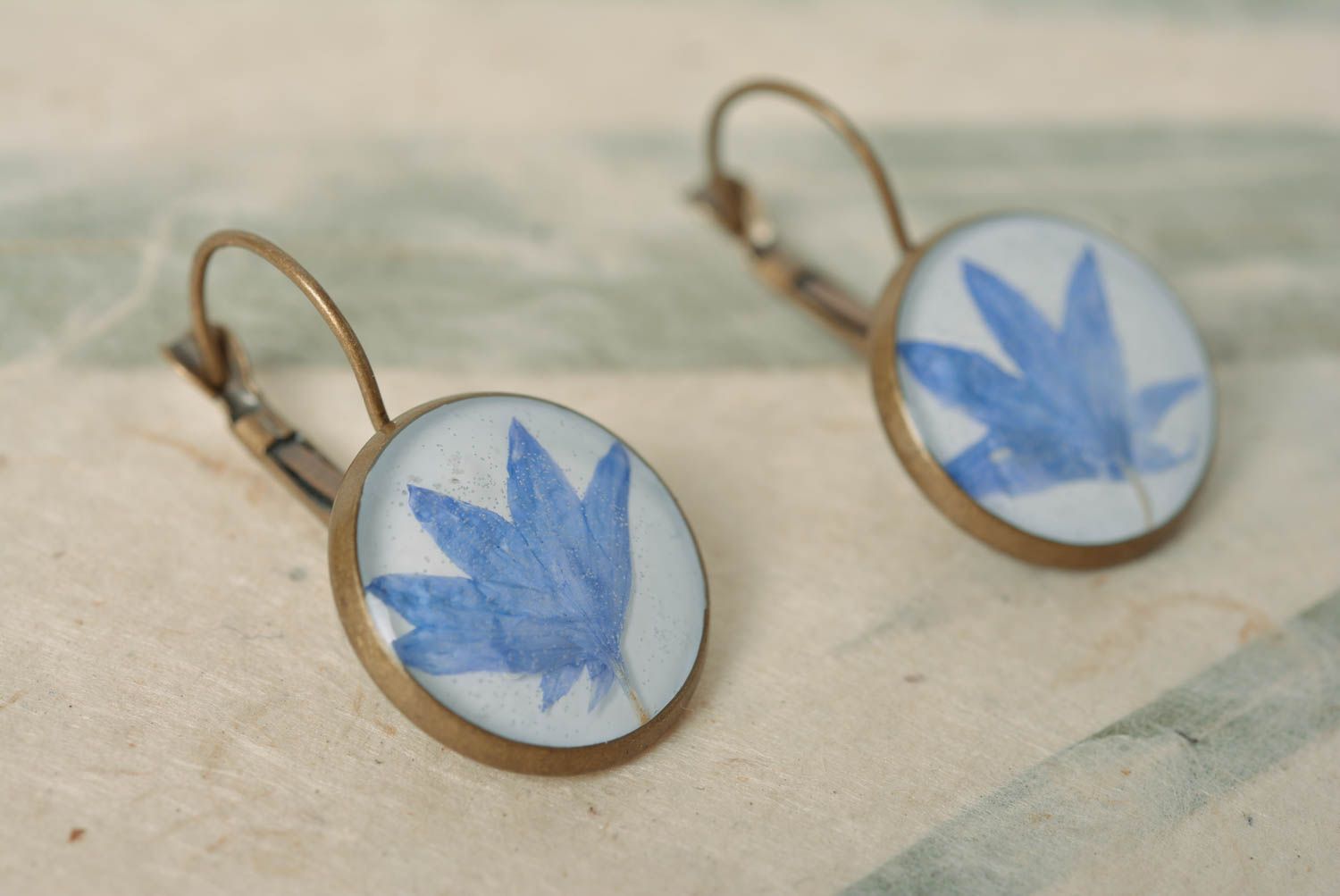 Beautiful homemade earrings with dried flowers coated with epoxy photo 1