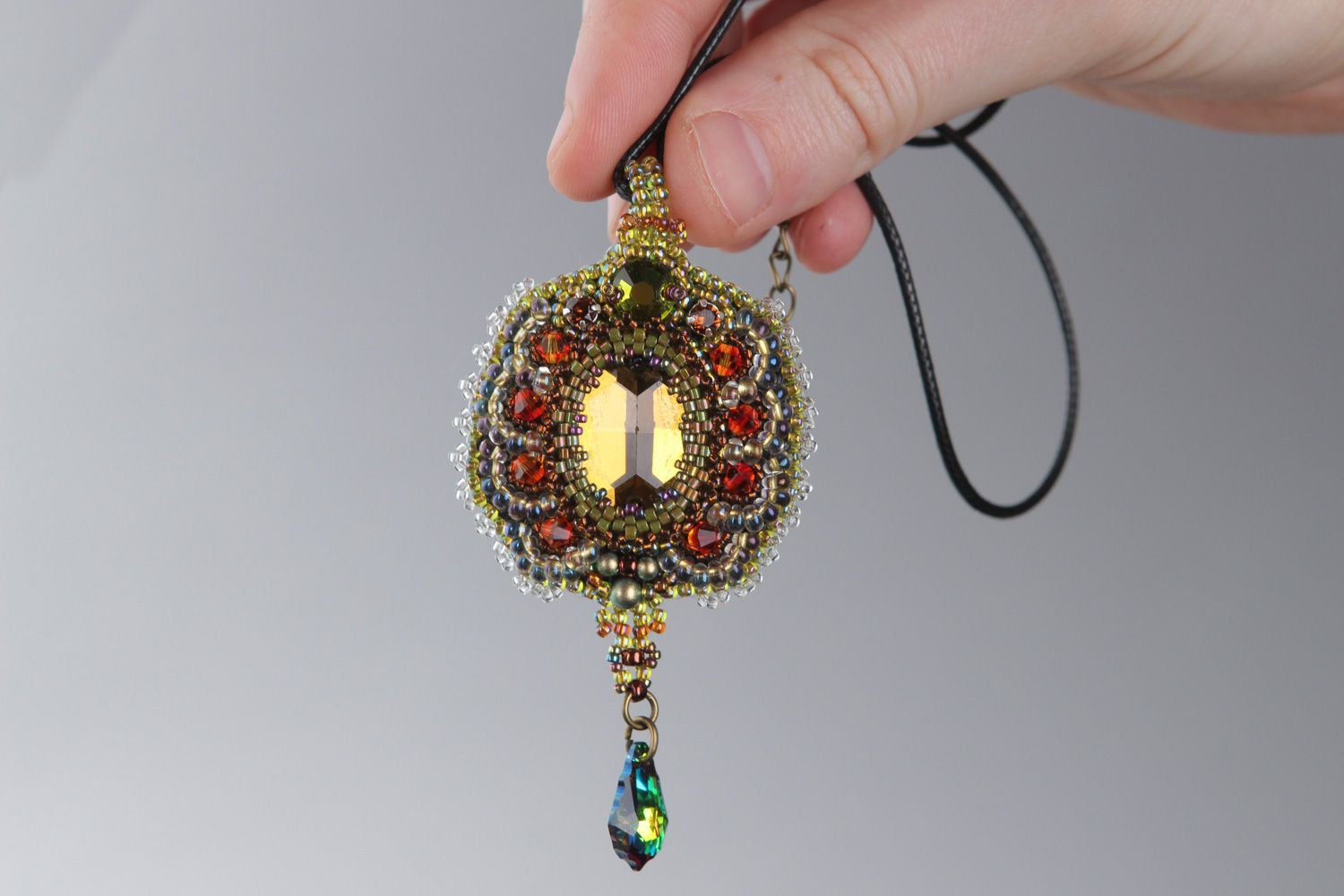 Handmade vintage golden-colored pendant embroidered with beads and crystals on cord photo 4
