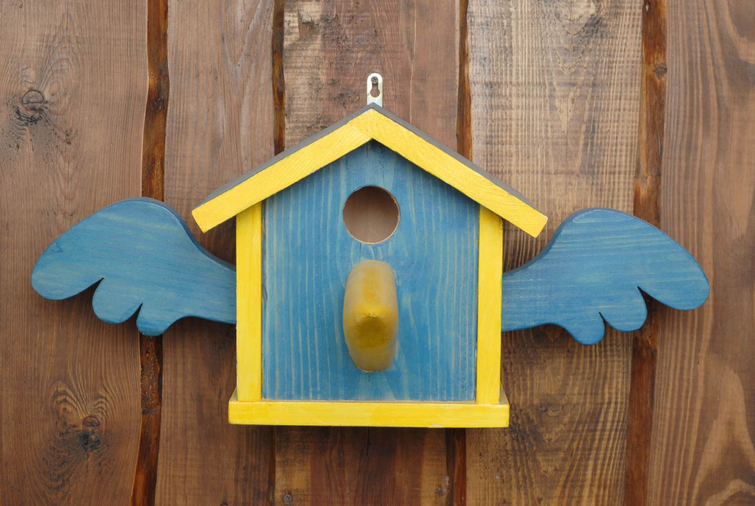 Painted wooden birdhouse with nose photo 3