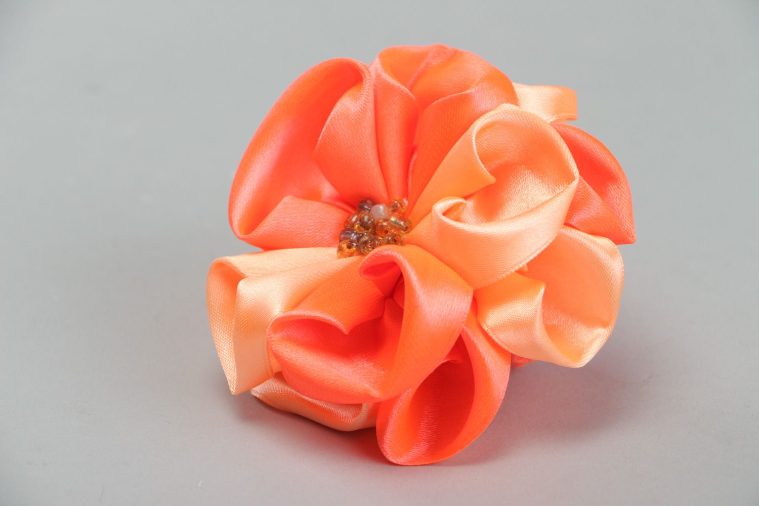 Handmade hair tie with volume flower of peach color sewn of satin fabric  photo 1