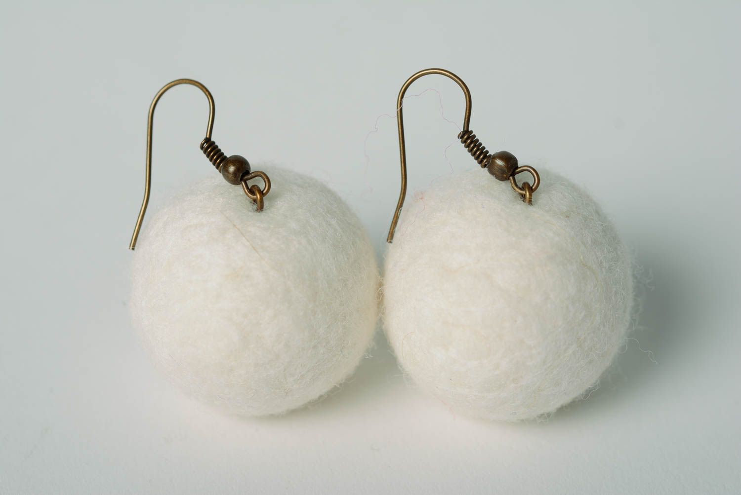 White handmade wool ball earrings created using needle felting technique photo 3
