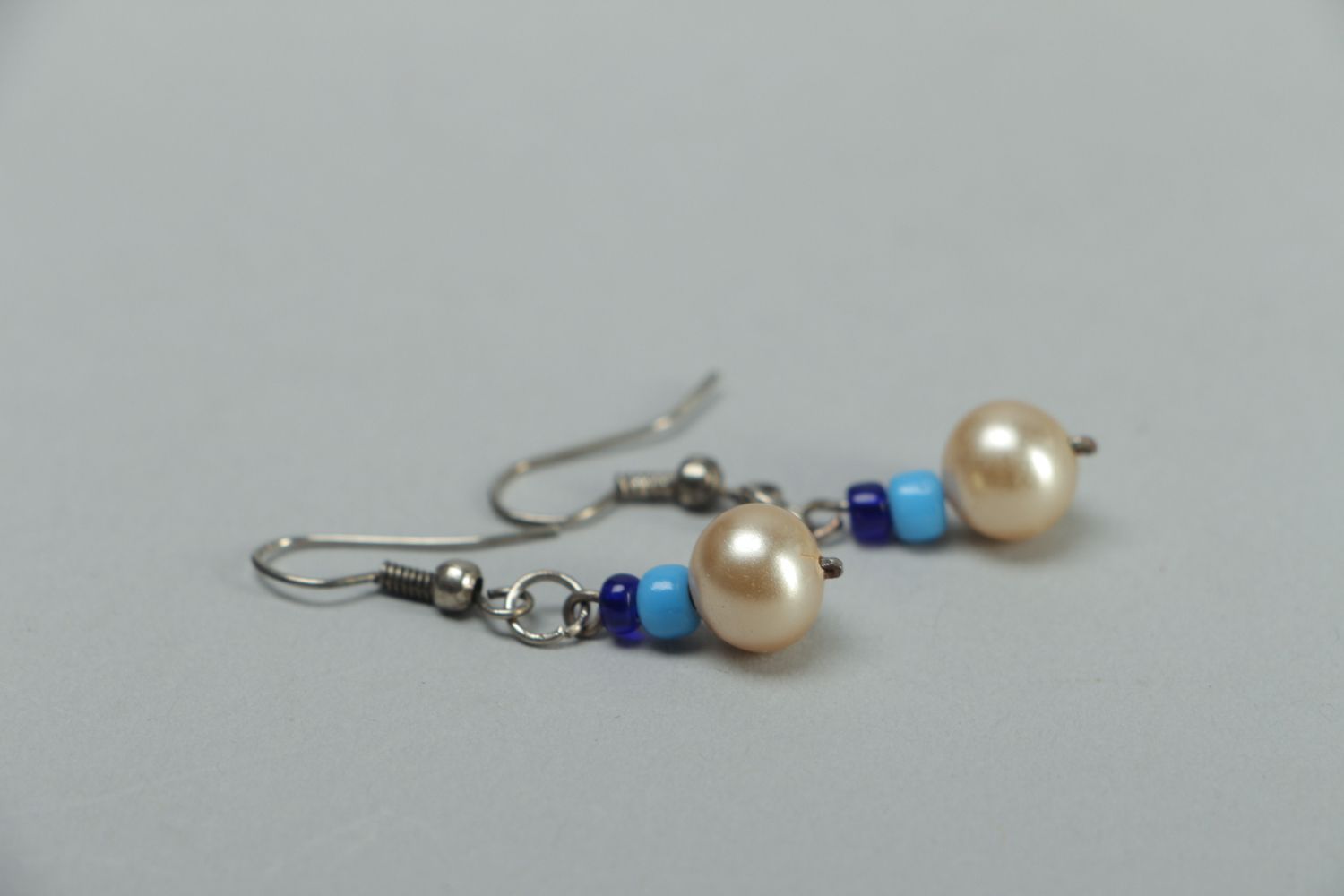 Metal earrings with pearl-like beads photo 2