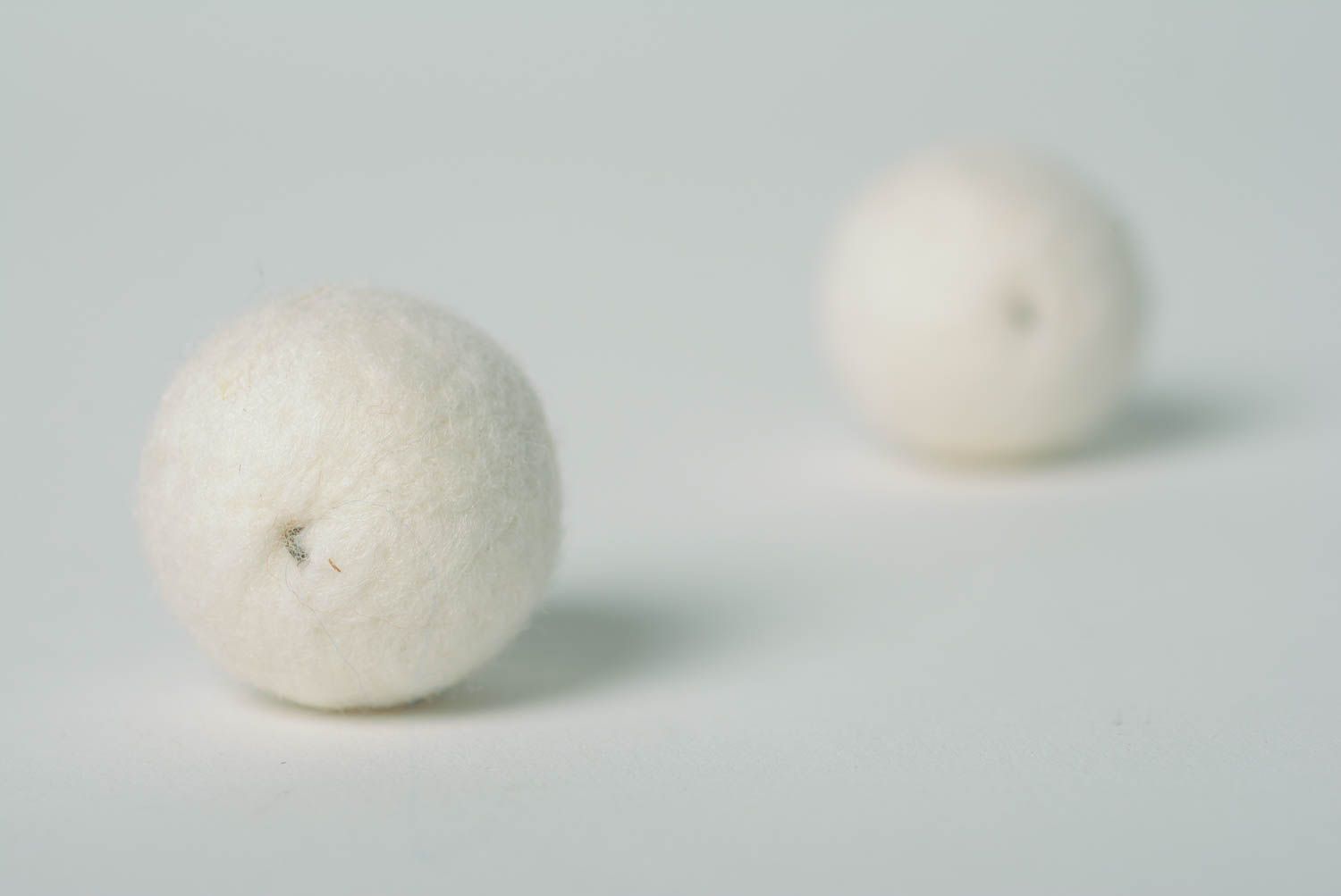 White handmade wool ball earrings created using needle felting technique photo 5