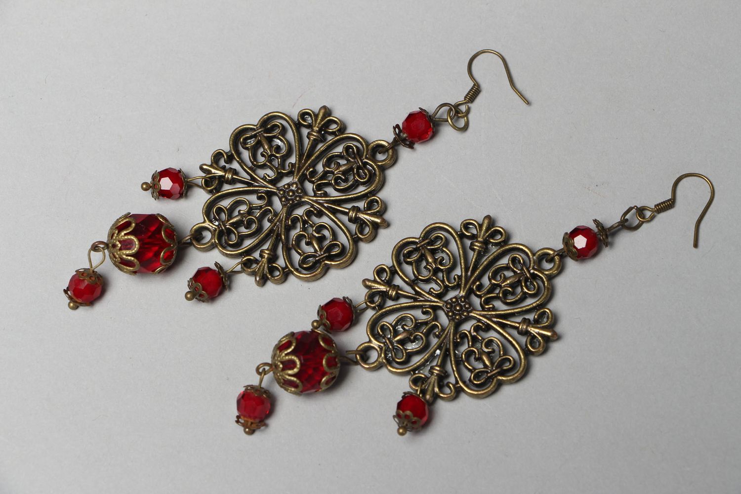 Metal earrings with glass beads of red color photo 1