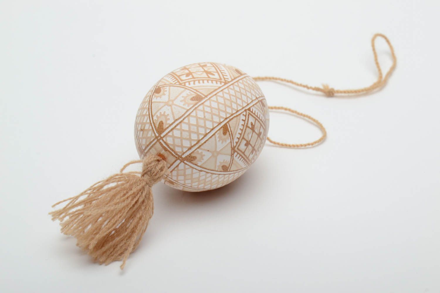 Handmade decorative light beige painted egg with geometric ornaments and tassel photo 4