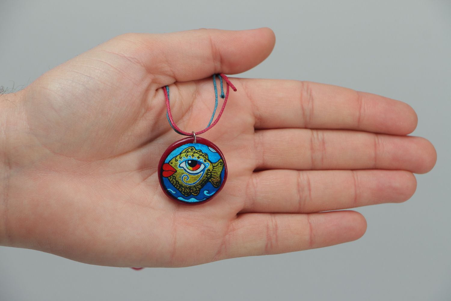 Round polymer clay pendant with drawing on a cord photo 3