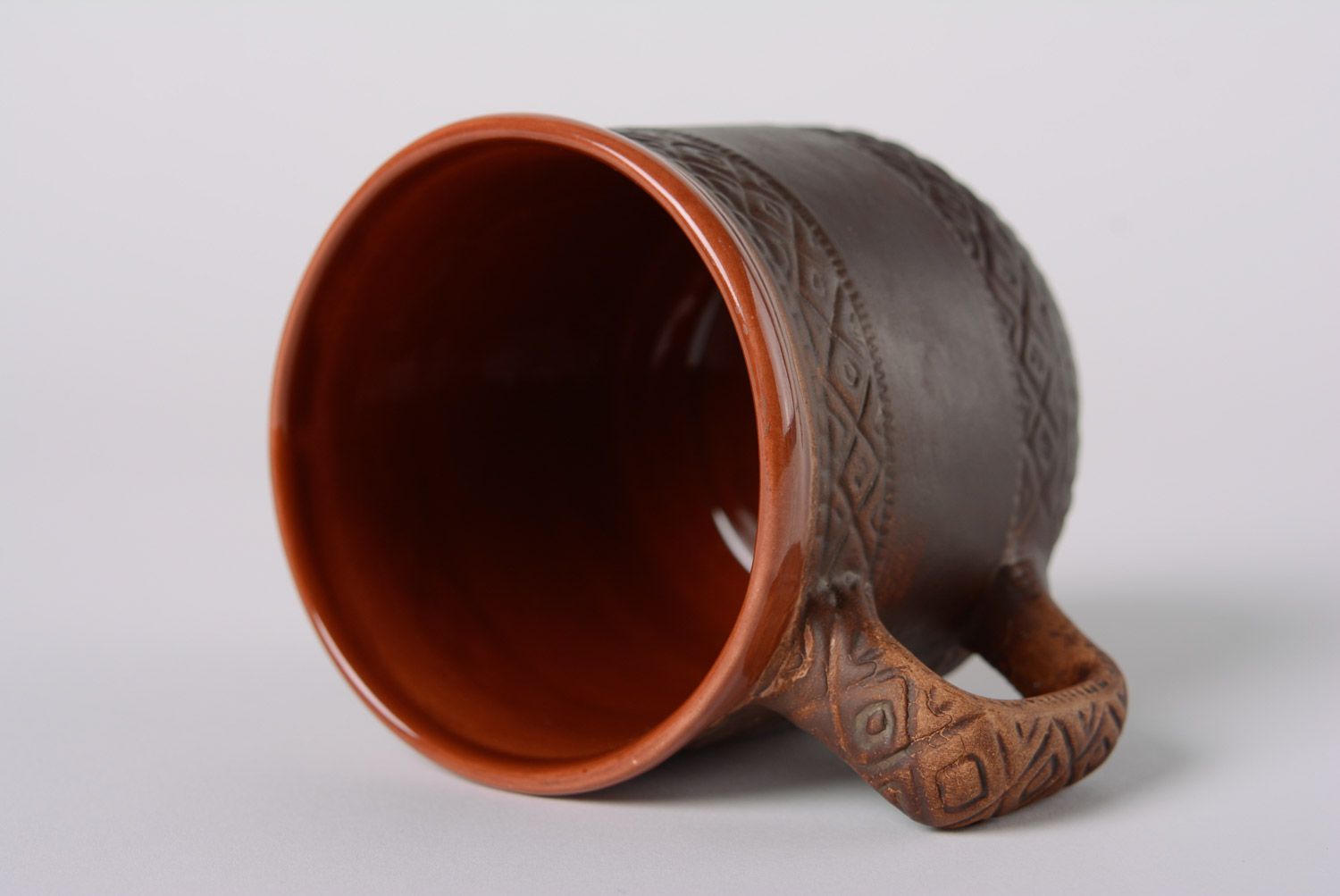 Rustic clay glazed cup with geometrical patterns and handle photo 2