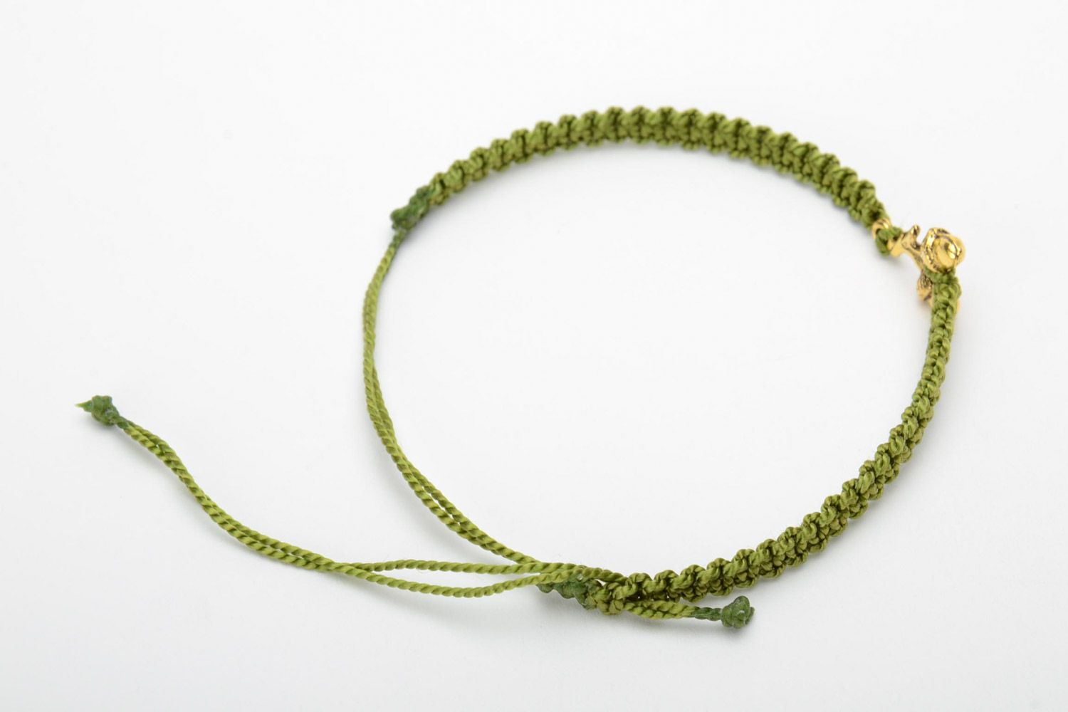 Women's handmade macrame woven thread bracelet of green color with metal charms in the shape of acorns photo 4