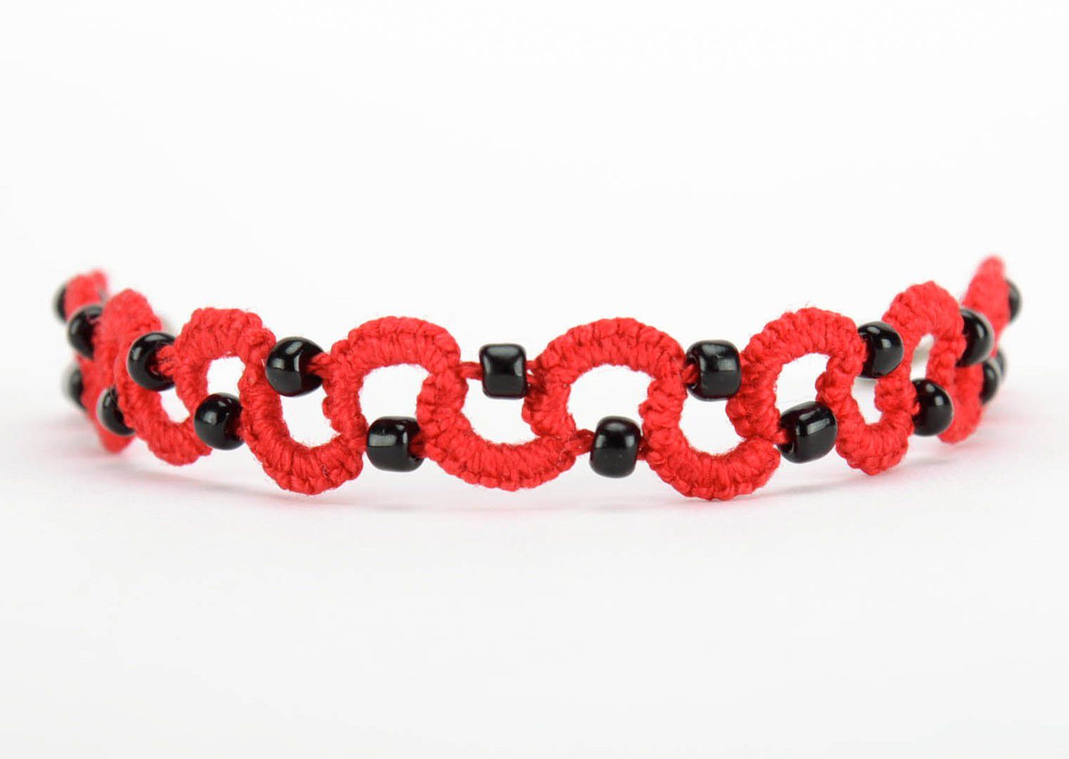 Red bracelet woven from cotton threads photo 1