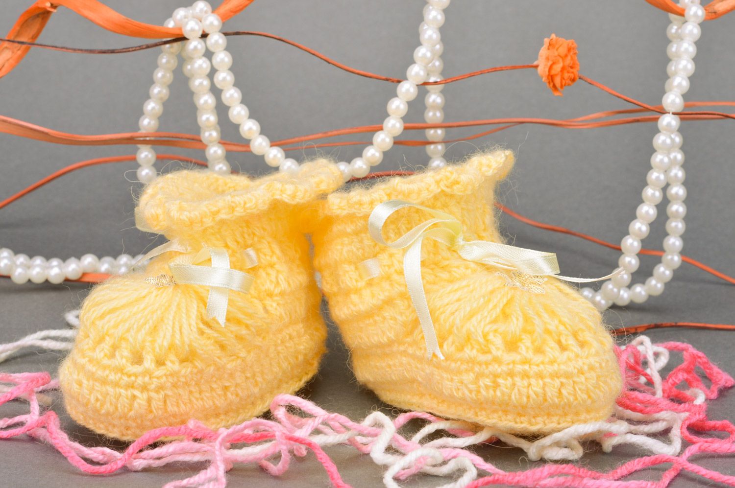 Handmade crocheted yellow baby booties made of acrylic with ribbon for girls photo 1