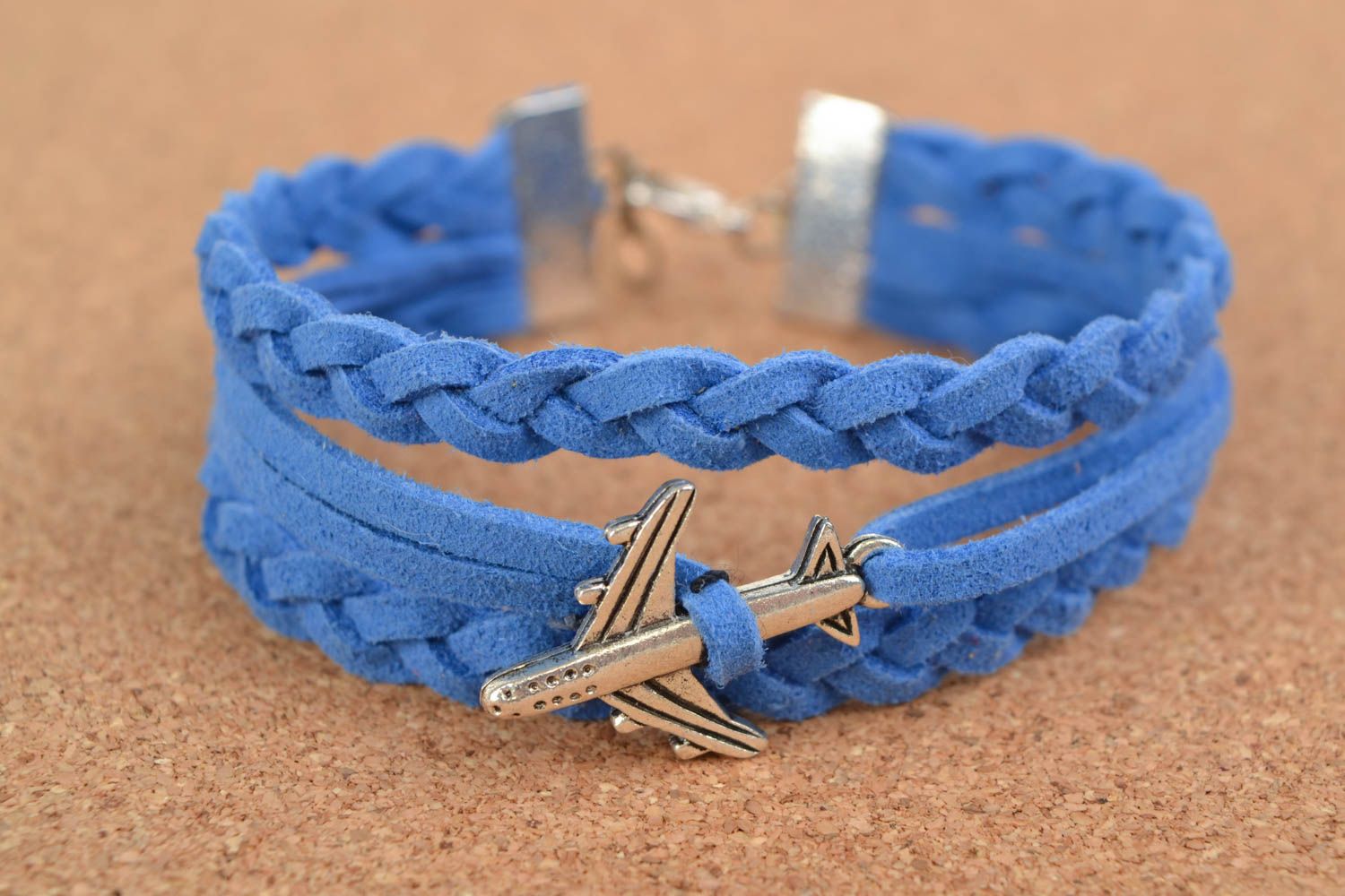 Bright blue handmade woven suede bracelet with charm in the shape of plane photo 1