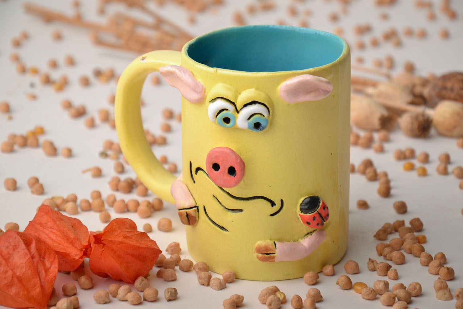 Yellow ceramic glazed kids' drinking cup with handle and piggy pattern photo 1