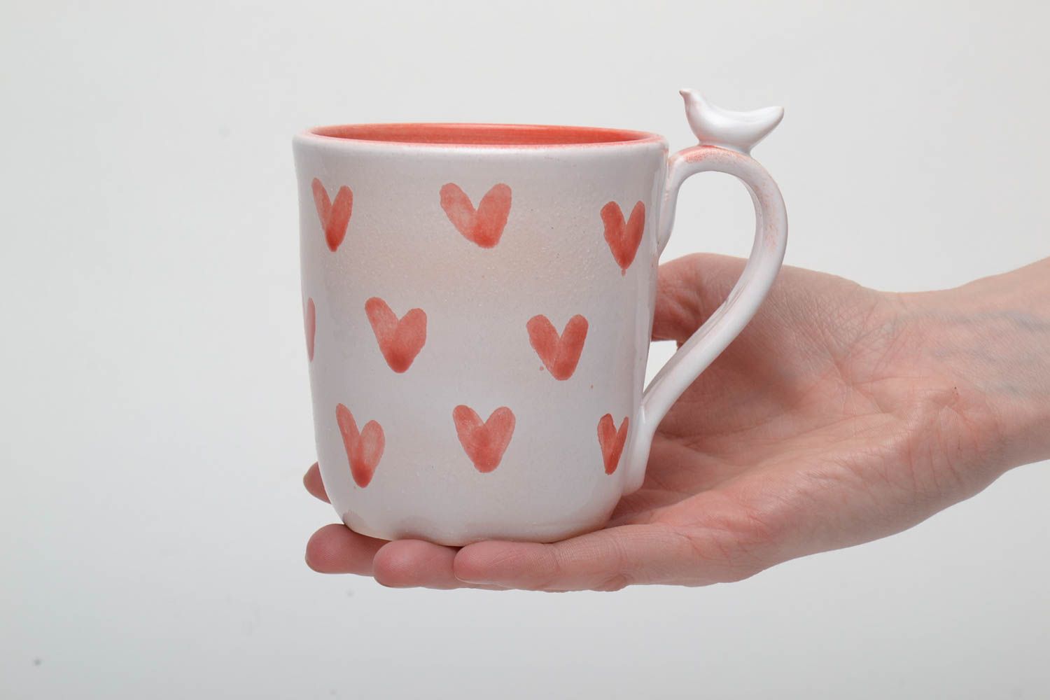 Ceramic handmade coffee cup with handle in white and orange color with hearts' pattern photo 5