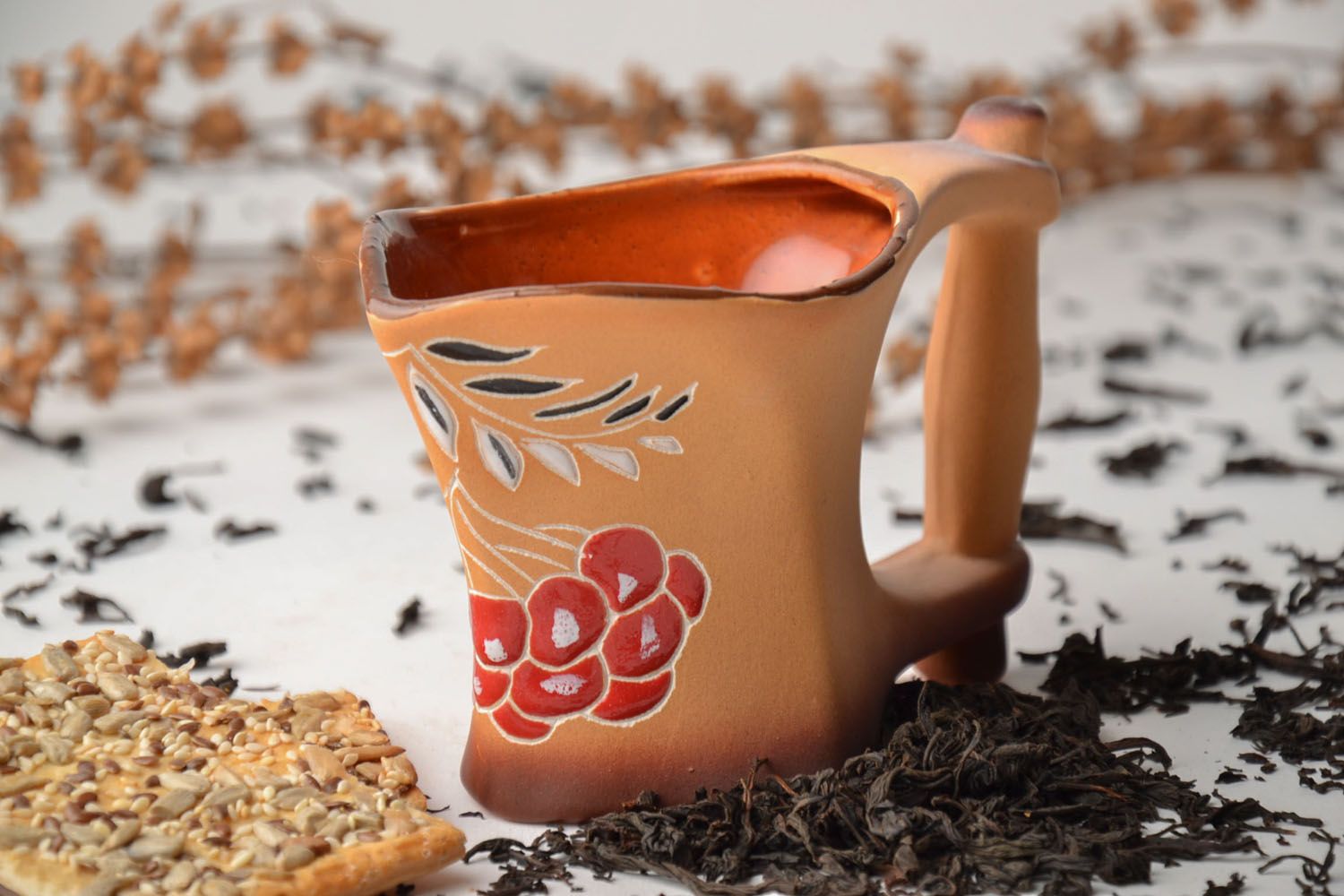 Handmade clay coffee cup with glaze in terracotta color with large handle and flower pattern photo 1