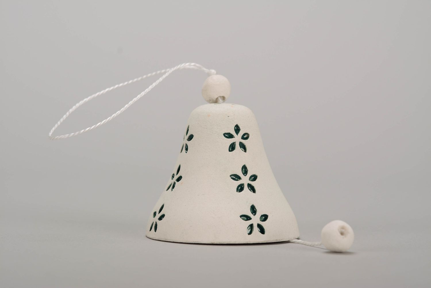 Bell made of white clay photo 1