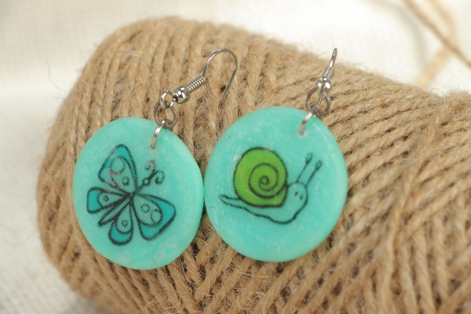 Turquoise plastic earrings with drawing photo 4