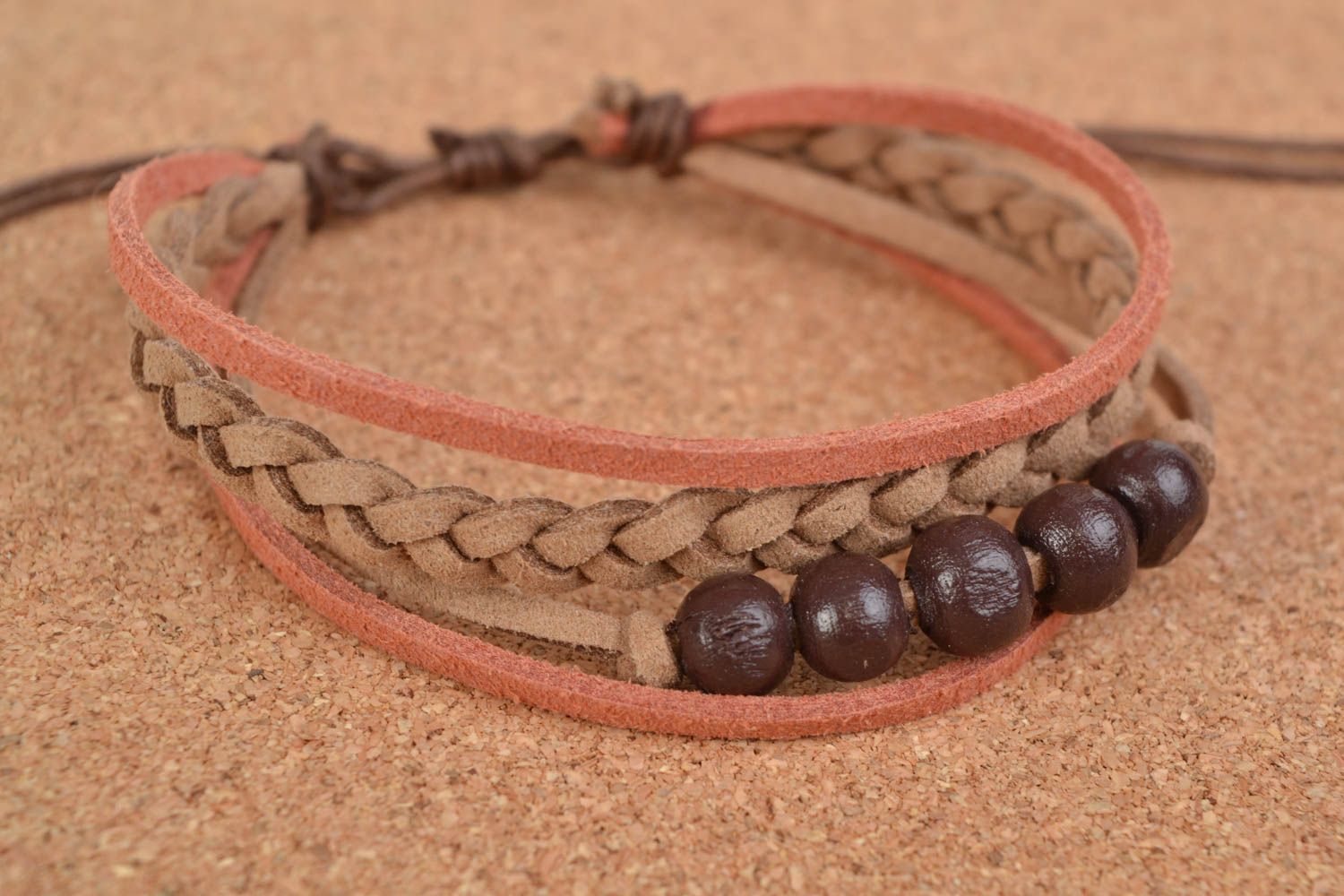 Handcrafted unique bracelet made of chamois-leather with entwined brown beads photo 1