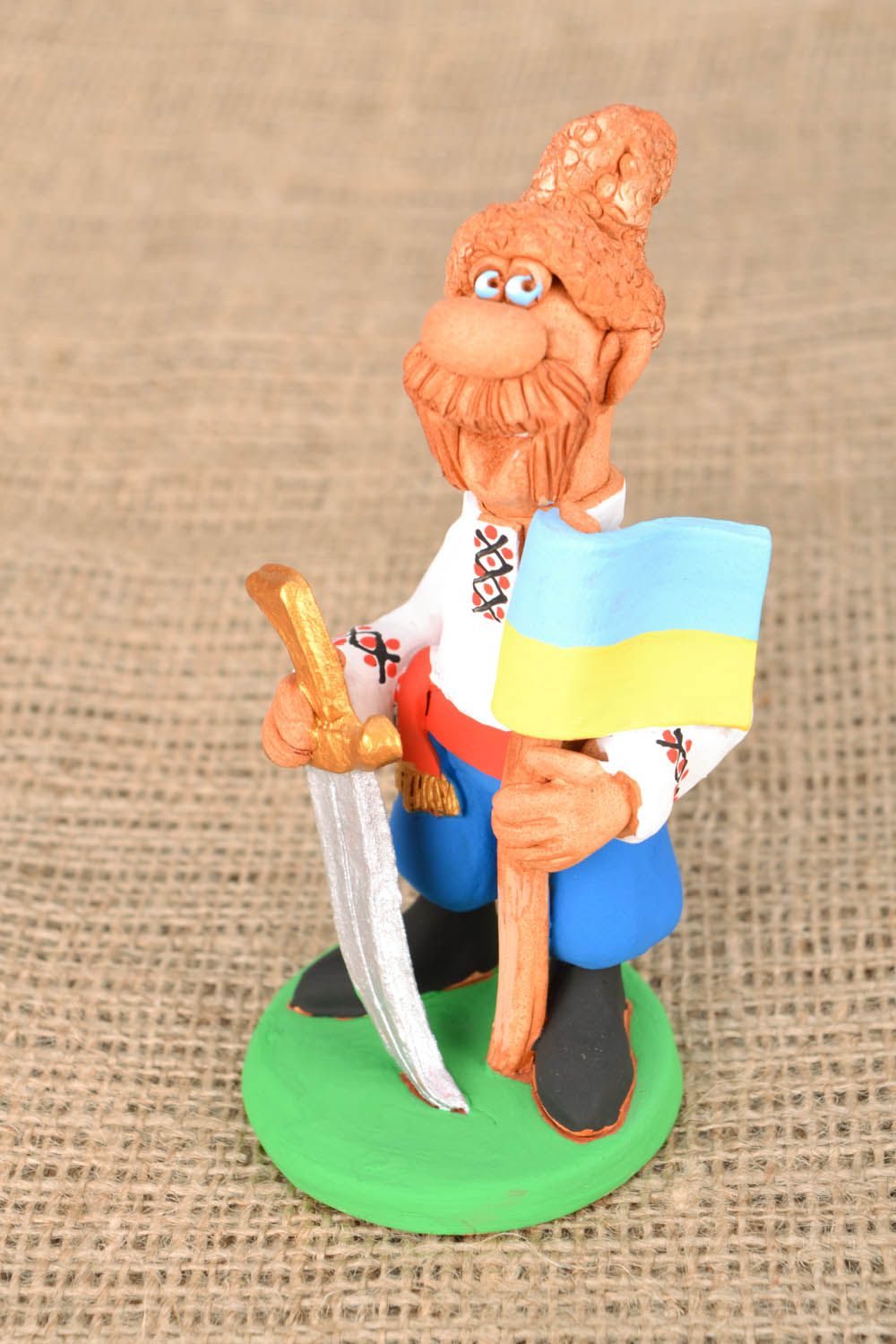 Homemade clay statuette Cossack with a Flag and a Saber photo 1
