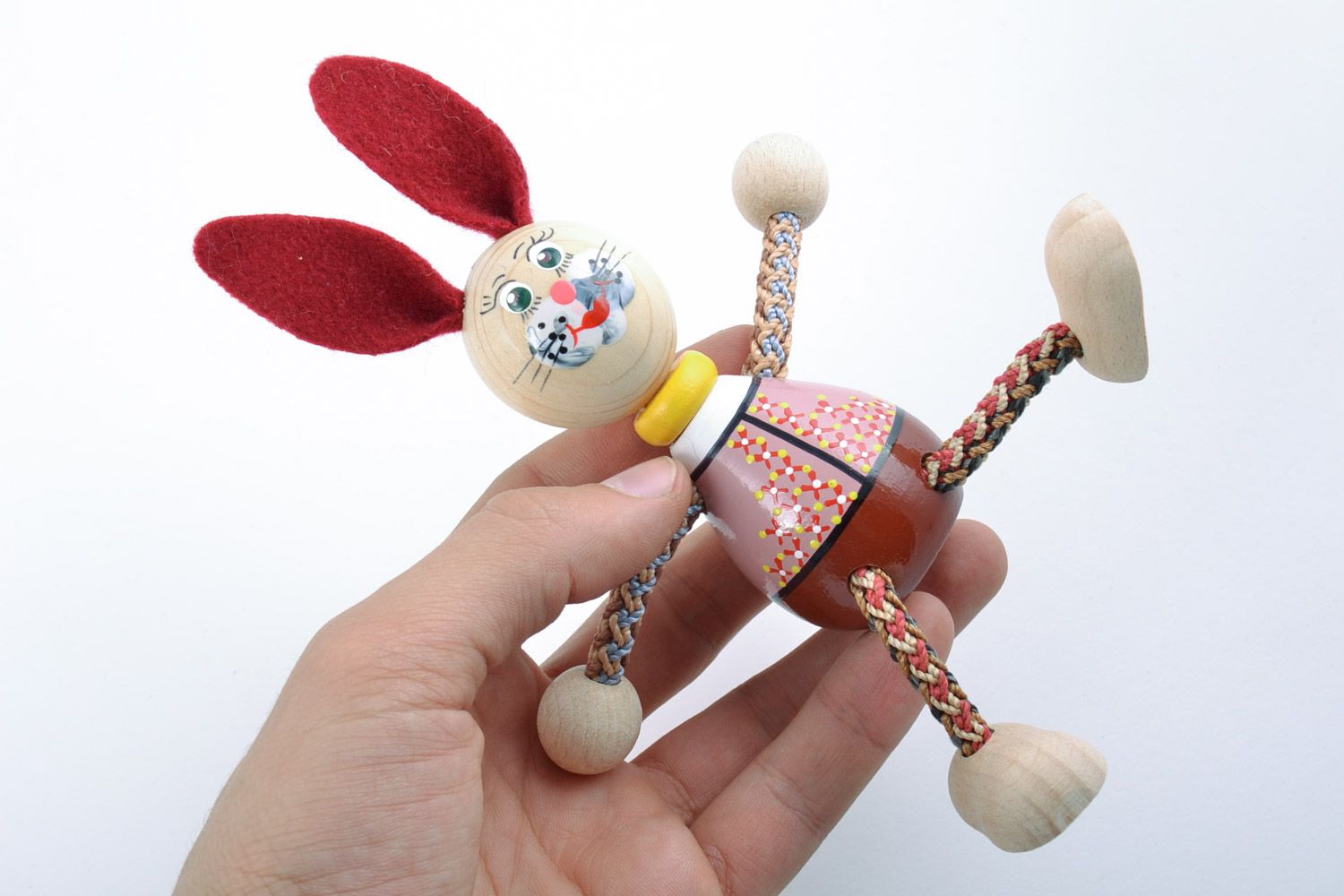 Small funny painted toy hand made of beech wood rabbit with red ears for kids photo 2