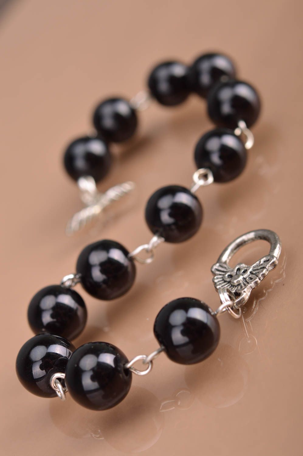 Designer women's wrist handmade bracelet with metal elements and black beads photo 5