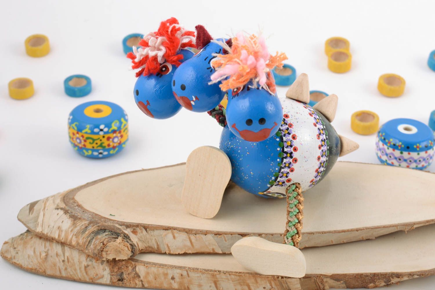 Jouet dragon bleu à trois têtes en bois peint de couleurs fait main écologique photo 1
