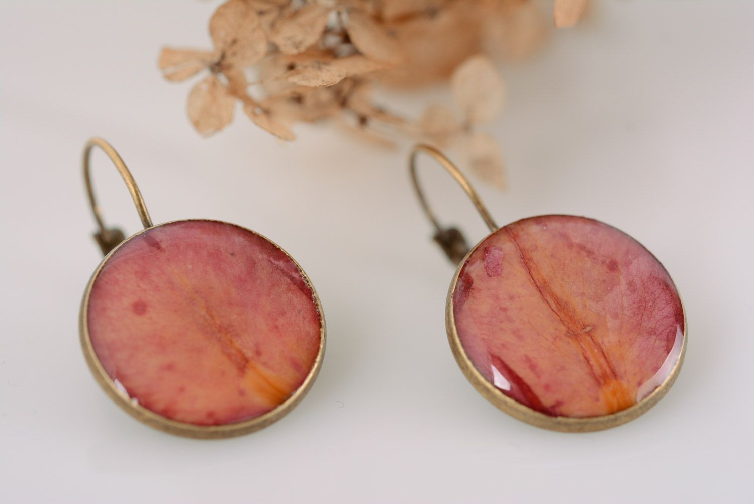 Handmade tender round dangle earrings with rose petals coated with epoxy resin  photo 1