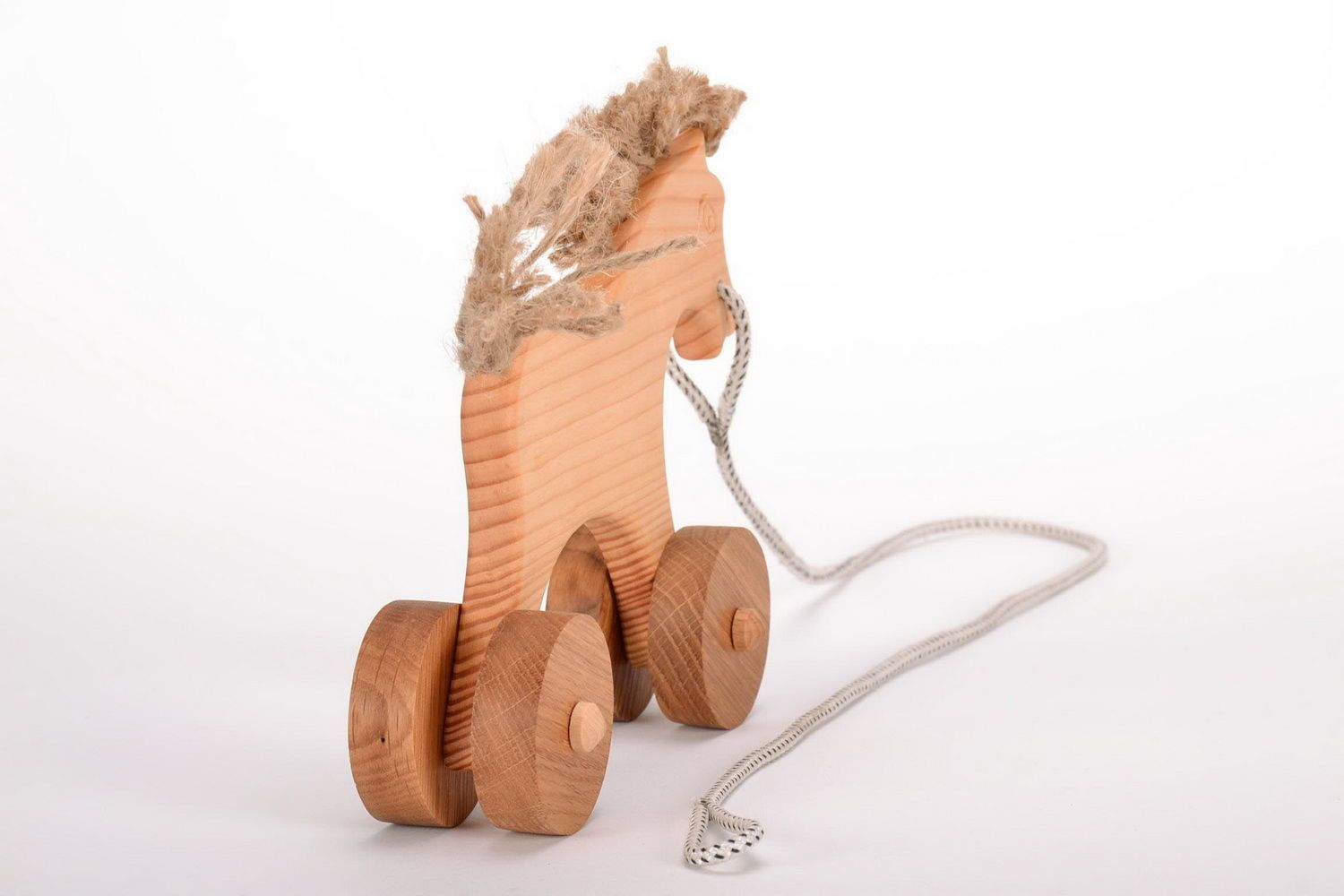 Деревянная игрушка каталка-лошадка фото 5