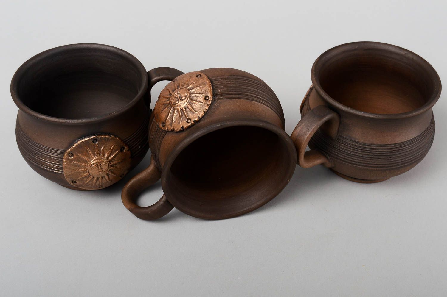 Set of 3 three clay coffee cups in dark brown color with molded sun pattern photo 3